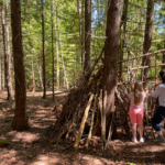 Familie mit Kindern an einer selbstgebauten Waldhütte im Balsaminenwald bei Bad Berka im Weimarer Land